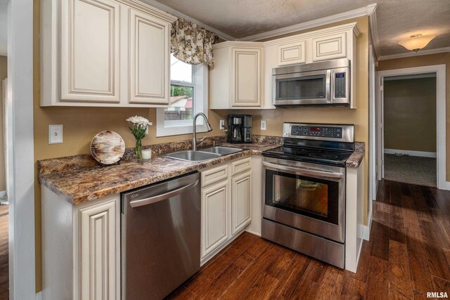 213 Texas Ave, Carterville, IL 62918 - kitchen with stainless steel appliances, a sink, cream cabinetry, and ornamental molding