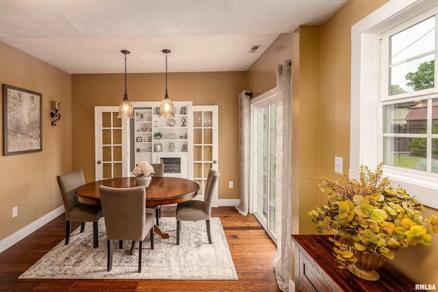 213 Texas Ave, Carterville, IL 62918 - dining room featuring wood finished floors, baseboards, french doors, and a glass covered fireplace