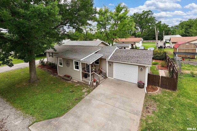 213 Texas Ave, Carterville, IL 62918 - view of front of home featuring an attached garage, driveway, and a shingled roof