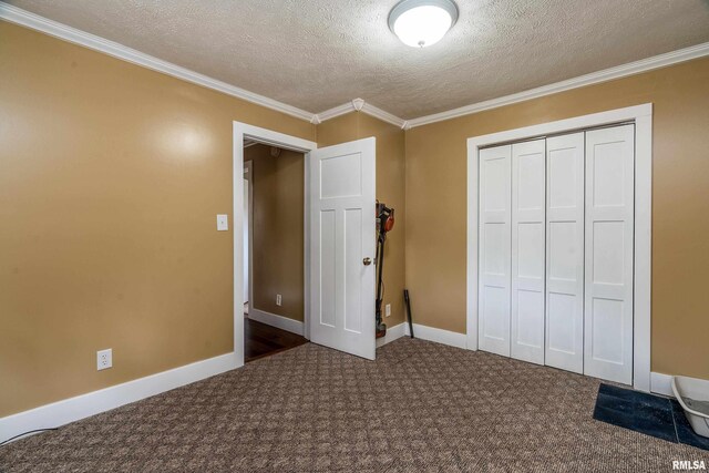213 Texas Ave, Carterville, IL 62918 - unfurnished bedroom with a textured ceiling, a closet, carpet floors, ornamental molding, and baseboards