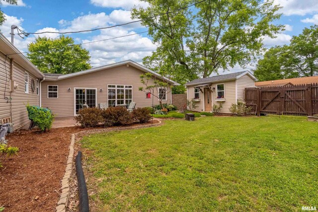 213 Texas Ave, Carterville, IL 62918 - back of house featuring a patio area, a gate, and an outbuilding