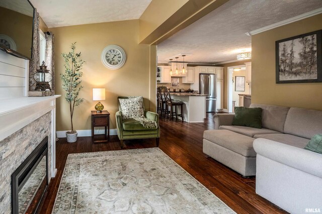 213 Texas Ave, Carterville, IL 62918 - living room featuring a stone fireplace, dark wood finished floors, ornamental molding, and baseboards