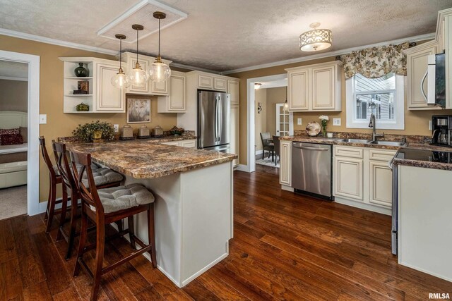 213 Texas Ave, Carterville, IL 62918 - kitchen featuring appliances with stainless steel finishes, a sink, a peninsula, pendant lighting, and crown molding