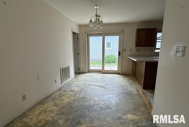 210 N State St, Christopher, IL 62822 - unfurnished dining area featuring a chandelier, concrete flooring, and baseboards