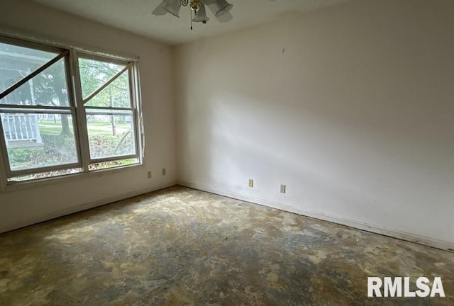 210 N State St, Christopher, IL 62822 - empty room featuring unfinished concrete flooring, ceiling fan, and baseboards