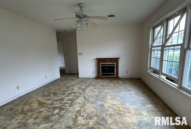 210 N State St, Christopher, IL 62822 - unfurnished living room featuring plenty of natural light, ceiling fan, a fireplace, and baseboards