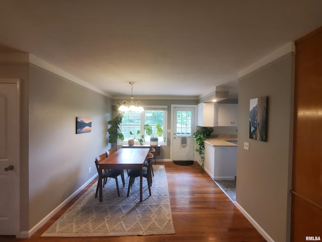 614 S Skyline Dr, Carbondale, IL 62901 - dining area featuring a chandelier, wood finished floors, baseboards, and ornamental molding