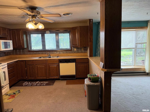 15 Dunn Ln, Goreville, IL 62939 - kitchen featuring white appliances, a sink, a textured ceiling, ceiling fan, and dark colored carpet