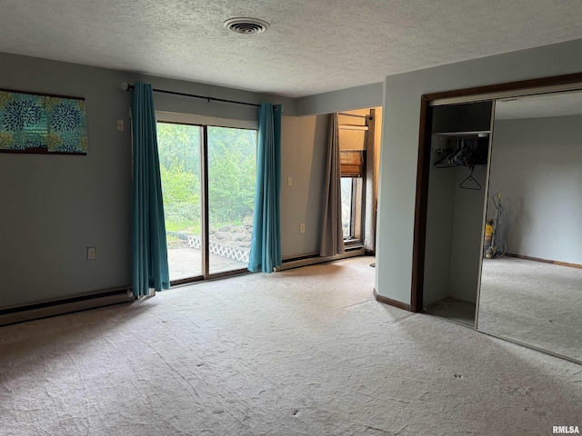15 Dunn Ln, Goreville, IL 62939 - unfurnished bedroom featuring carpet, a baseboard radiator, access to exterior, a closet, and a textured ceiling