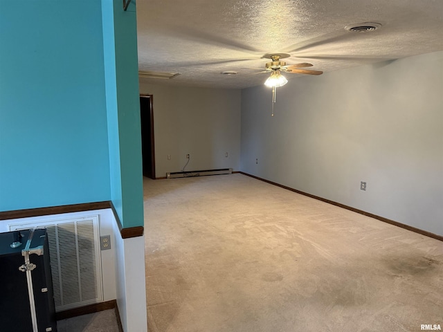 15 Dunn Ln, Goreville, IL 62939 - unfurnished room with ceiling fan, carpet, a textured ceiling, a baseboard heating unit, and baseboards