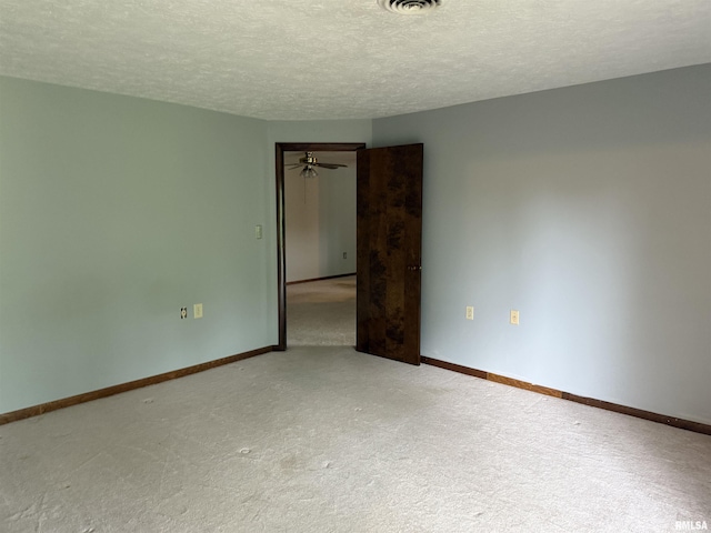 15 Dunn Ln, Goreville, IL 62939 - spare room featuring a textured ceiling, carpet flooring, and baseboards