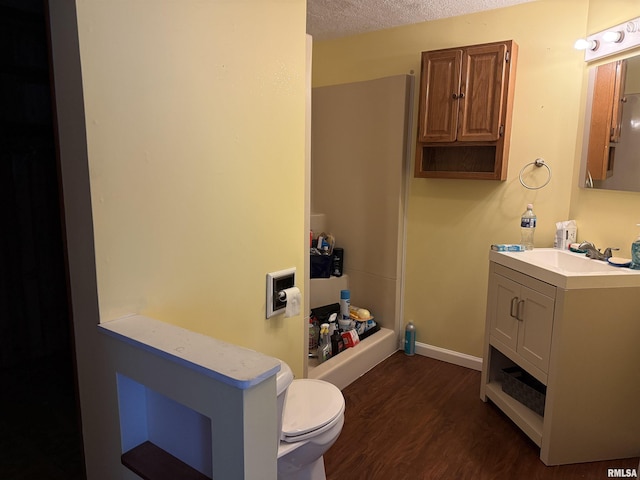 15 Dunn Ln, Goreville, IL 62939 - full bath with wood finished floors, toilet, vanity, a textured ceiling, and baseboards