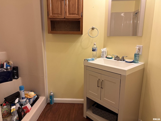 15 Dunn Ln, Goreville, IL 62939 - full bathroom with wood finished floors, vanity, a shower, and baseboards