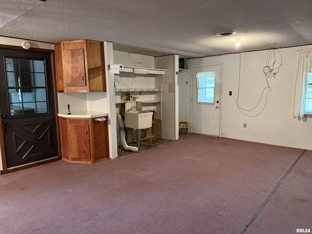 15 Dunn Ln, Goreville, IL 62939 - kitchen with brown cabinets, healthy amount of natural light, carpet flooring, and a textured ceiling