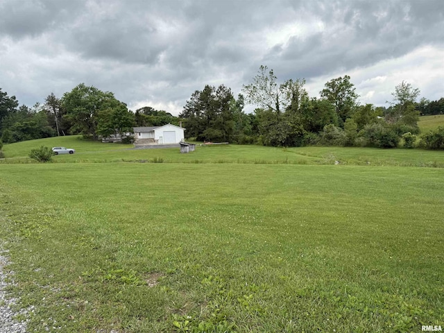 15 Dunn Ln, Goreville, IL 62939 - view of green lawn featuring a garage and a view of rural / pastoral area