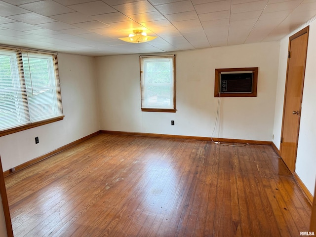 101 Nile St, Anna, IL 62906 - empty room with hardwood / wood-style floors, baseboards, and an AC wall unit