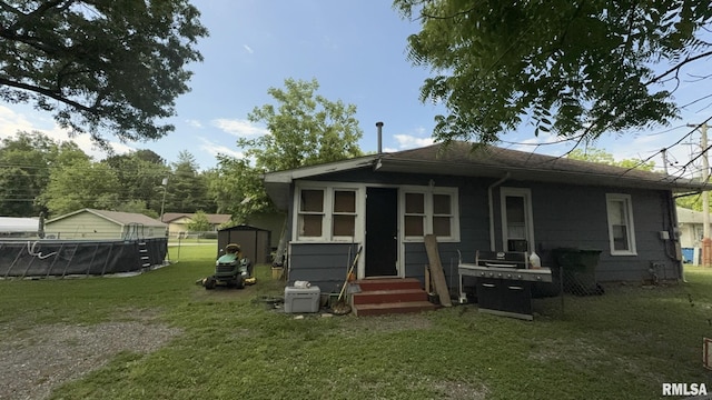114 S 9th St, Benton, IL 62812 - rear view of property with entry steps and a lawn