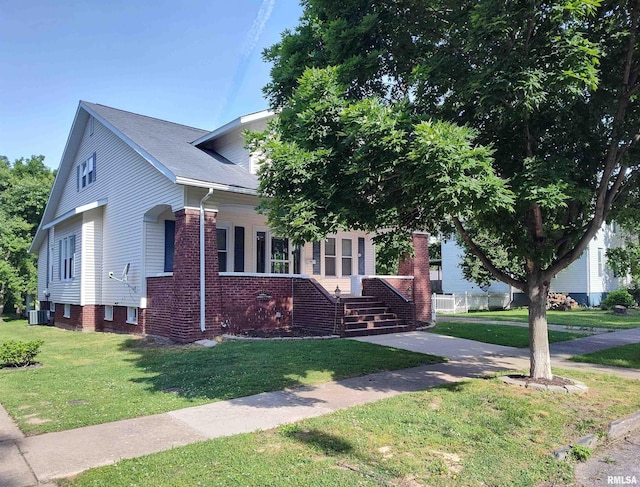 704 S Washington St, Mcleansboro, IL 62859 - view of front facade with central AC, a front yard, and brick siding