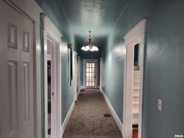 704 S Washington St, Mcleansboro, IL 62859 - corridor with a chandelier, dark carpet, and baseboards
