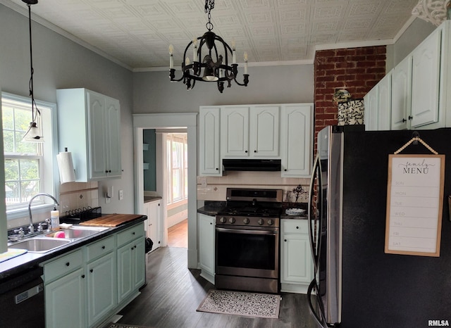 704 S Washington St, Mcleansboro, IL 62859 - kitchen featuring freestanding refrigerator, stainless steel gas stove, a sink, range hood, and ornamental molding