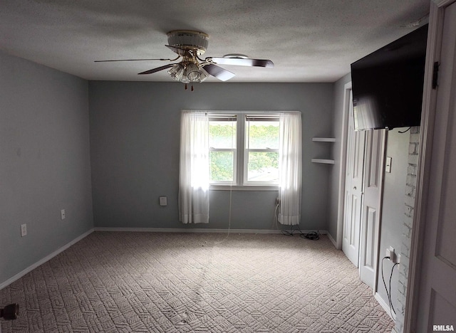 704 S Washington St, Mcleansboro, IL 62859 - carpeted empty room featuring a ceiling fan, a textured ceiling, and baseboards