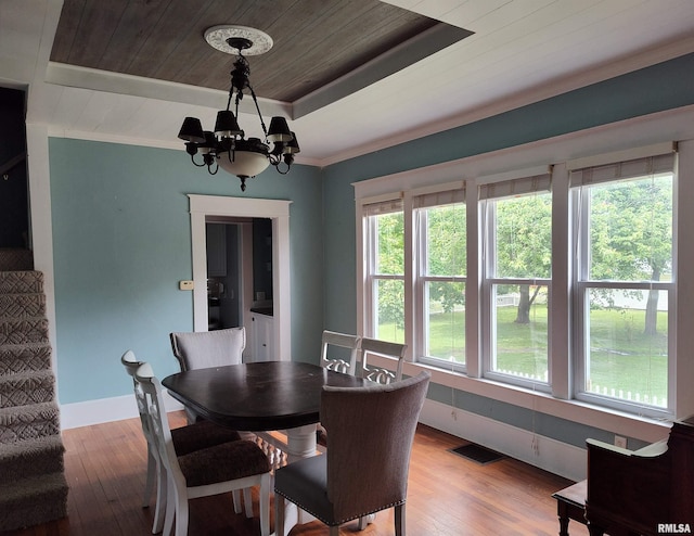 704 S Washington St, Mcleansboro, IL 62859 - dining room with wooden ceiling, light wood finished floors, a chandelier, a tray ceiling, and baseboards