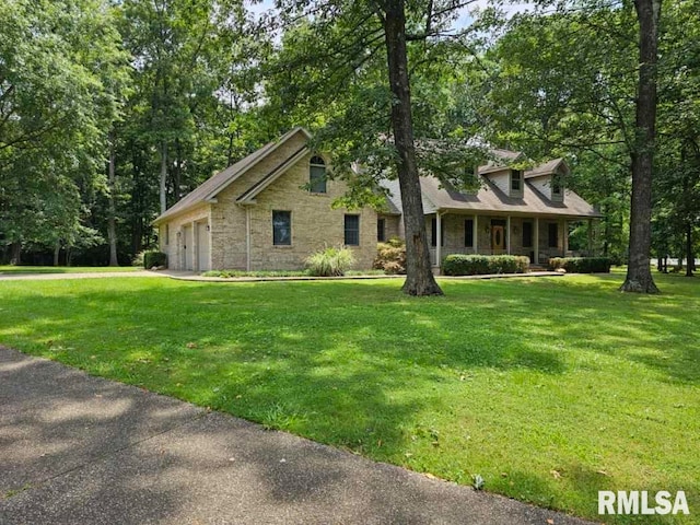 9 Fawn Dr, Fairfield, IL 62837 - view of front of house featuring stone siding, a front lawn, a garage, and a porch