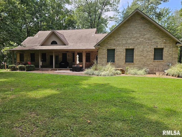 9 Fawn Dr, Fairfield, IL 62837 - view of front of house with a front lawn, brick siding, and a patio