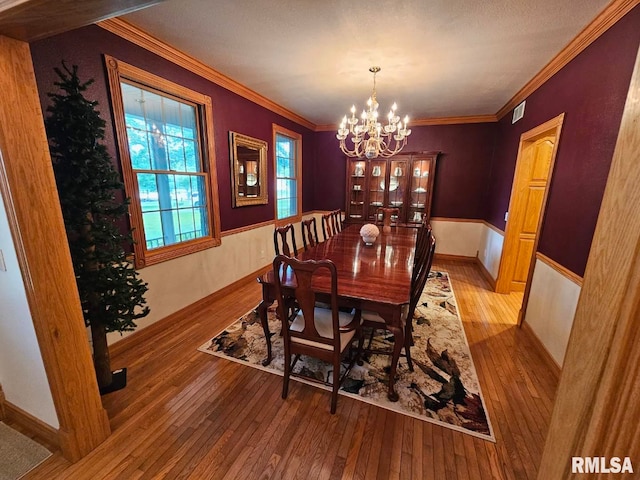 9 Fawn Dr, Fairfield, IL 62837 - dining space featuring hardwood / wood-style flooring, a chandelier, ornamental molding, and baseboards