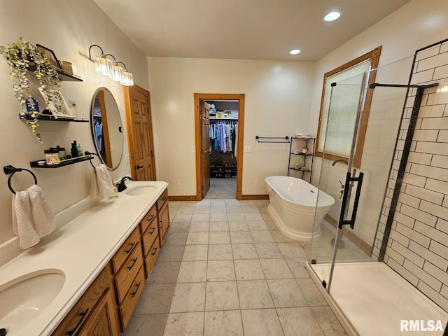 9 Fawn Dr, Fairfield, IL 62837 - full bath with double vanity, a freestanding tub, a shower stall, a spacious closet, and recessed lighting