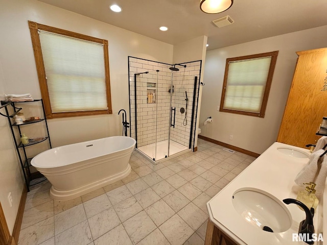 9 Fawn Dr, Fairfield, IL 62837 - full bath featuring a stall shower, baseboards, a freestanding bath, double vanity, and recessed lighting