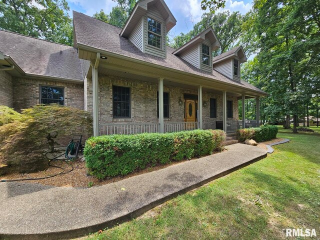 9 Fawn Dr, Fairfield, IL 62837 - view of front of house with a porch, a front yard, brick siding, and roof with shingles