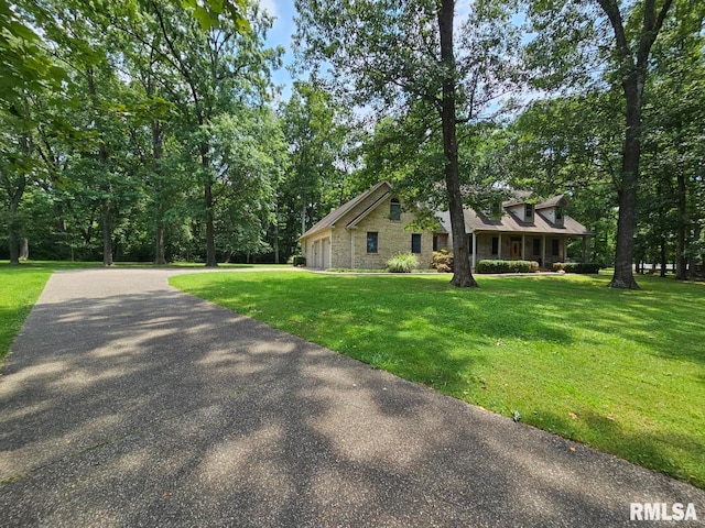 9 Fawn Dr, Fairfield, IL 62837 - view of home's exterior with a yard, a garage, asphalt driveway, and stone siding
