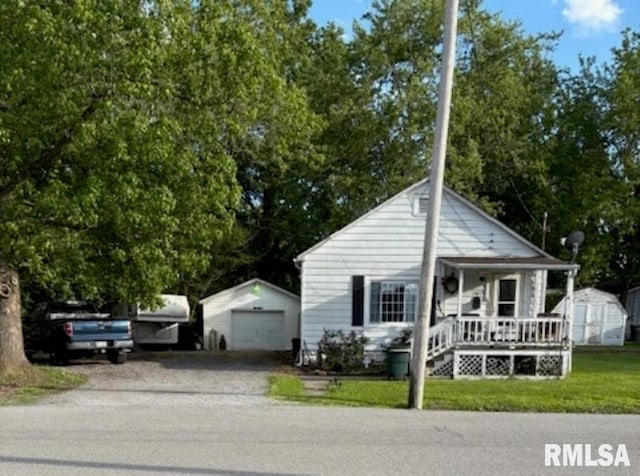 1505 W Chestnut St, Marion, IL 62959 - view of front facade with covered porch, a garage, driveway, and a front lawn