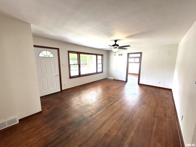 1318 E 4th St, Centralia, IL 62801 - unfurnished living room featuring dark wood-type flooring, a ceiling fan, and baseboards