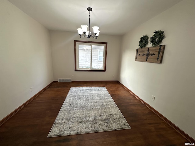 1318 E 4th St, Centralia, IL 62801 - unfurnished room featuring a chandelier, dark wood-type flooring, and baseboards