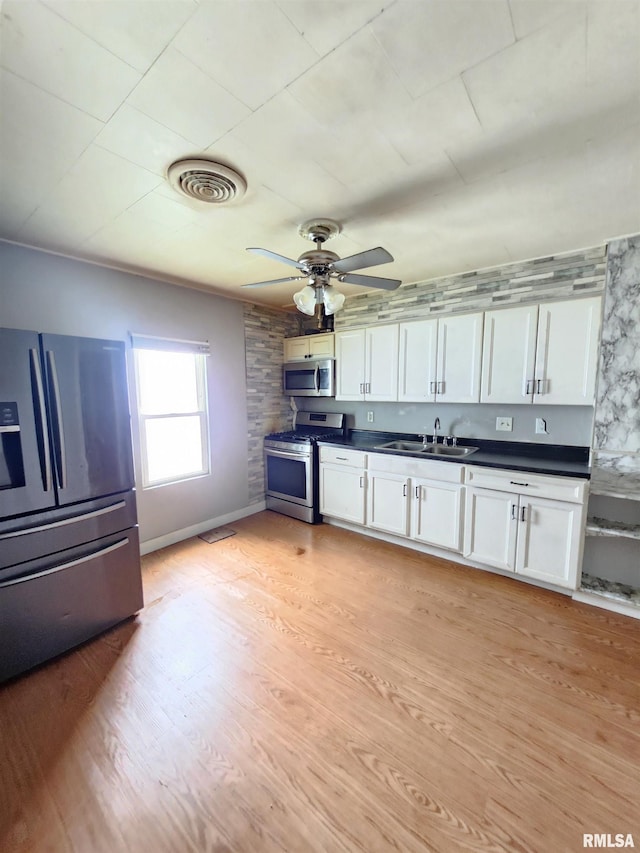 528 N 15th St, Murphysboro, IL 62966 - kitchen featuring appliances with stainless steel finishes, a sink, dark countertops, and white cabinets