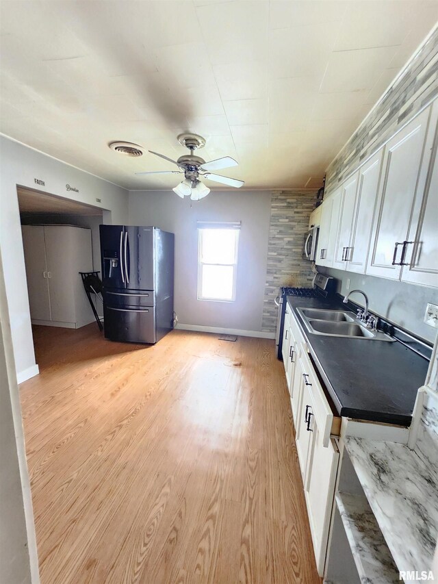528 N 15th St, Murphysboro, IL 62966 - kitchen with stainless steel appliances, a sink, dark countertops, and white cabinetry