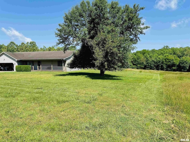 3685 Lick Creek Rd, Anna, IL 62906 - view of green lawn with an attached garage and a porch