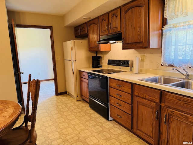 3685 Lick Creek Rd, Anna, IL 62906 - kitchen featuring black electric range, under cabinet range hood, a sink, light flooring, and freestanding refrigerator