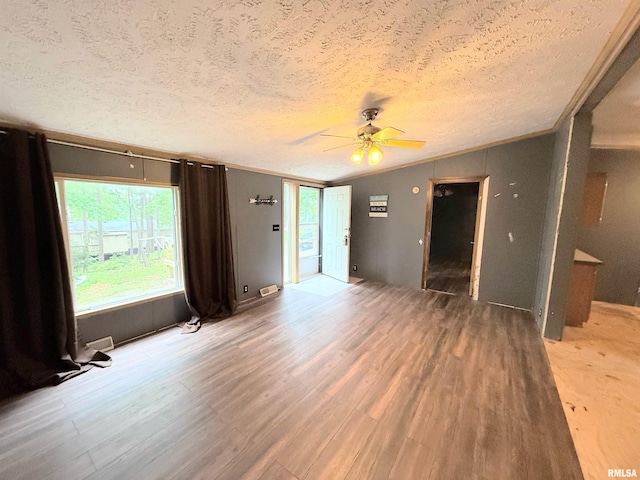 45 White Sands Rd, Creal Springs, IL 62922 - empty room featuring a textured ceiling, light wood-style flooring, ceiling fan, lofted ceiling, and crown molding
