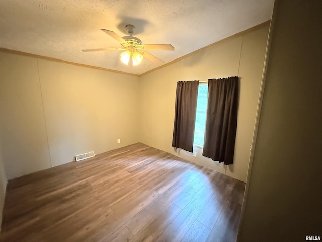 45 White Sands Rd, Creal Springs, IL 62922 - empty room featuring vaulted ceiling, a textured ceiling, wood finished floors, ceiling fan, and ornamental molding