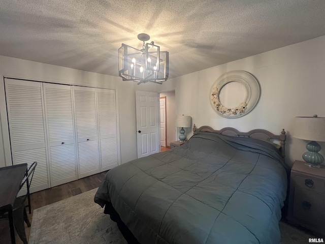 1150 Lakeview Dr, Creal Springs, IL 62922 - bedroom with a closet, dark wood-type flooring, a chandelier, and a textured ceiling