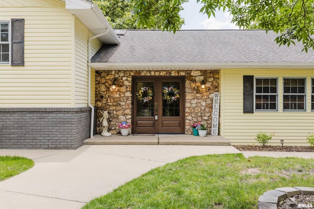 12897 Egypt Shores Dr, Creal Springs, IL 62922 - view of exterior entry with stone siding, a shingled roof, and french doors
