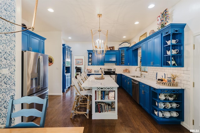12897 Egypt Shores Dr, Creal Springs, IL 62922 - kitchen with open shelves, blue cabinetry, stainless steel appliances, a chandelier, and recessed lighting