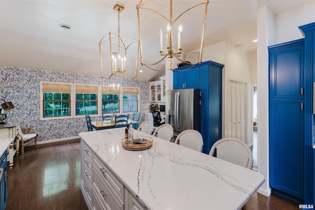 12897 Egypt Shores Dr, Creal Springs, IL 62922 - kitchen with a chandelier, dark wood finished floors, wallpapered walls, stainless steel fridge with ice dispenser, and light stone countertops