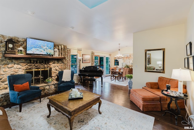 12897 Egypt Shores Dr, Creal Springs, IL 62922 - living area with wood-type flooring, a chandelier, a stone fireplace, and vaulted ceiling