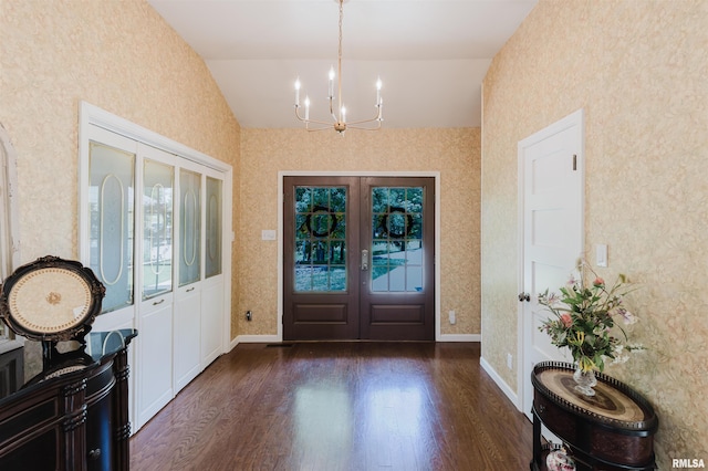 12897 Egypt Shores Dr, Creal Springs, IL 62922 - foyer entrance with vaulted ceiling, a chandelier, french doors, dark wood finished floors, and wallpapered walls