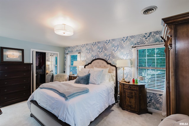 12897 Egypt Shores Dr, Creal Springs, IL 62922 - bedroom featuring wallpapered walls, light carpet, and a closet