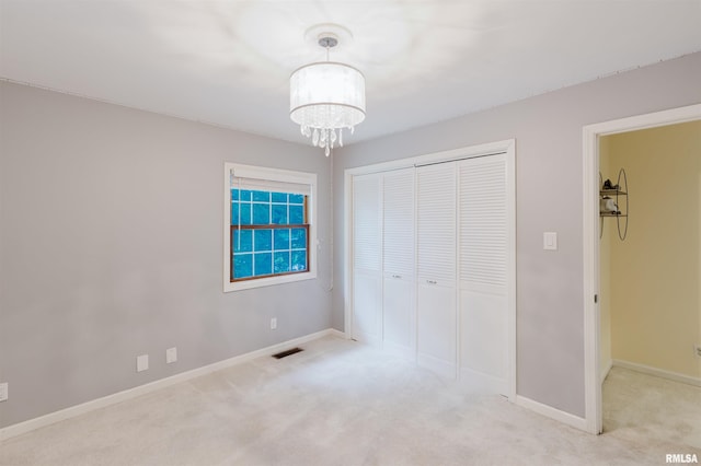 12897 Egypt Shores Dr, Creal Springs, IL 62922 - unfurnished bedroom featuring a closet, carpet flooring, a chandelier, and baseboards